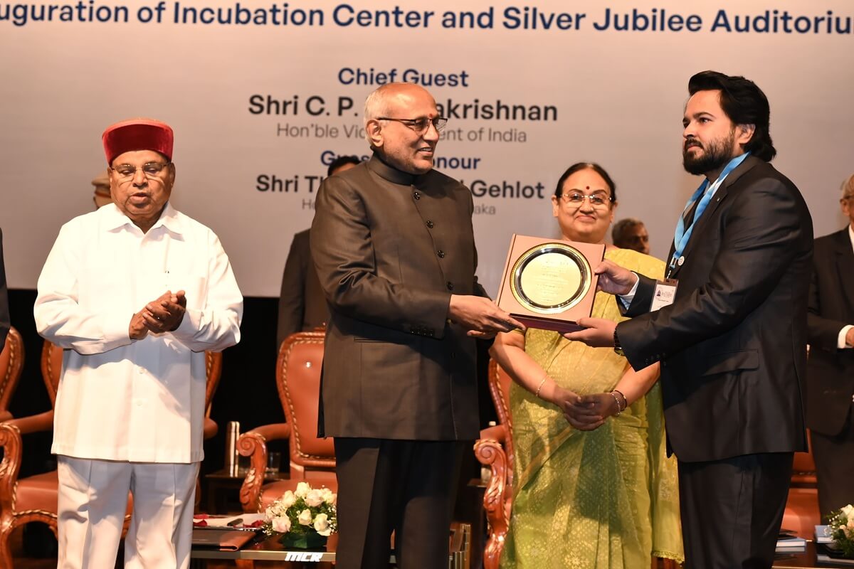 Ashish Kumar receiving alumni recognition from Vice President of India C. P. Radhakrishnan at CMRIT.